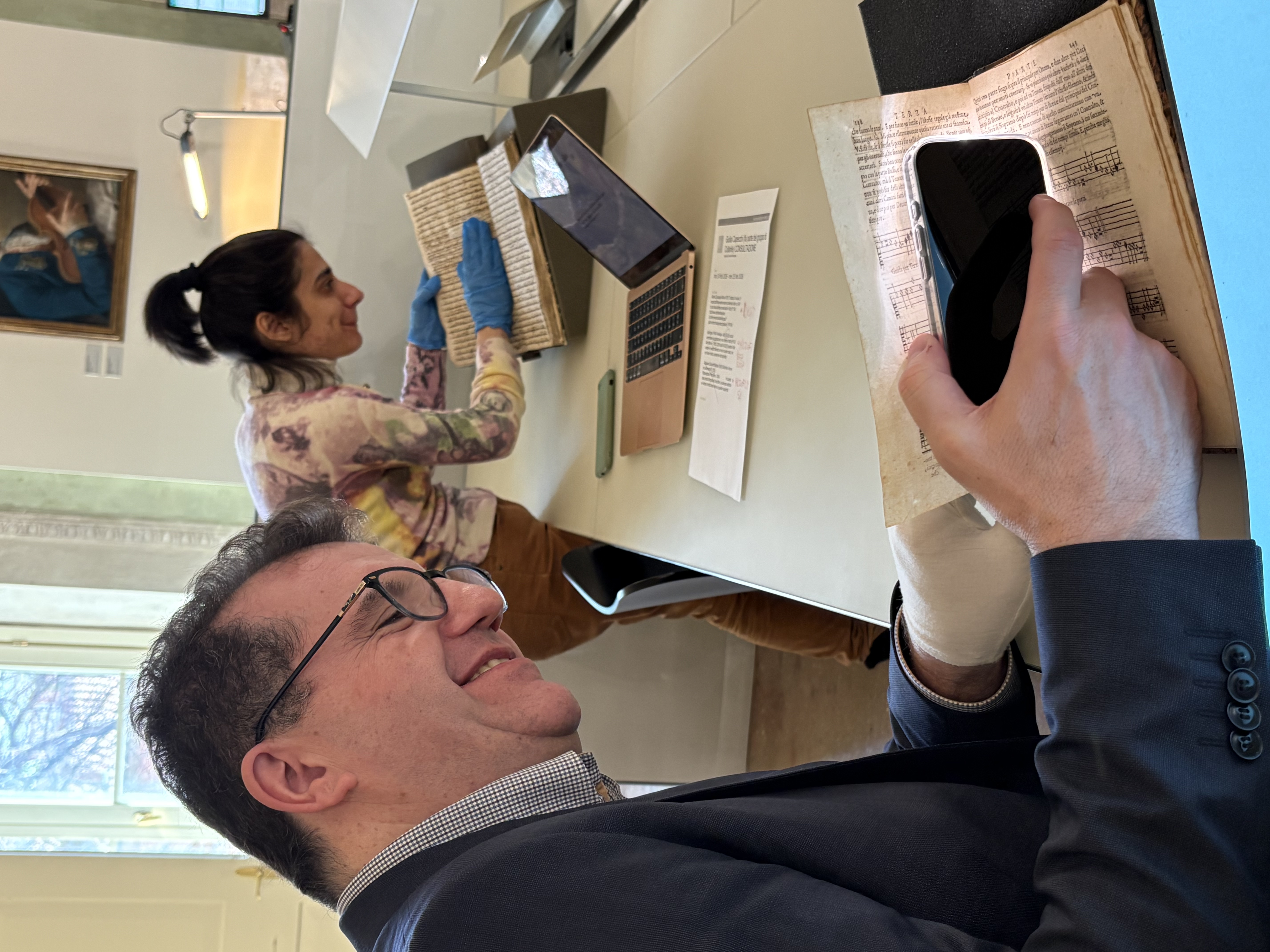 Luigi and Giulia looking at the manuscripts